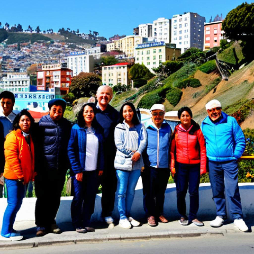 A diverse group of individuals, including men and women of various ages, enjoying a sunny day in Valparaíso, Chile. They are dressed in casual, modest, and appropriate attire suitable for exploring a vibrant coastal city, such as light jackets, comfortable trousers, and closed-toe shoes. All subjects are fully clothed. The background features the iconic colorful hillside houses of Valparaíso, adorned with intricate street art and graffiti, cascading down towards the Pacific Ocean. Old funiculars (*ascensores*) can be seen on the hills. The scene captures the lively, artistic atmosphere of the city. Professional photography, high-resolution, sharp focus, natural daylight, vivid colors, realistic style, perfect anatomy, correct proportions, natural poses, well-formed hands, proper finger count, safe for work, appropriate content, fully clothed, family-friendly.